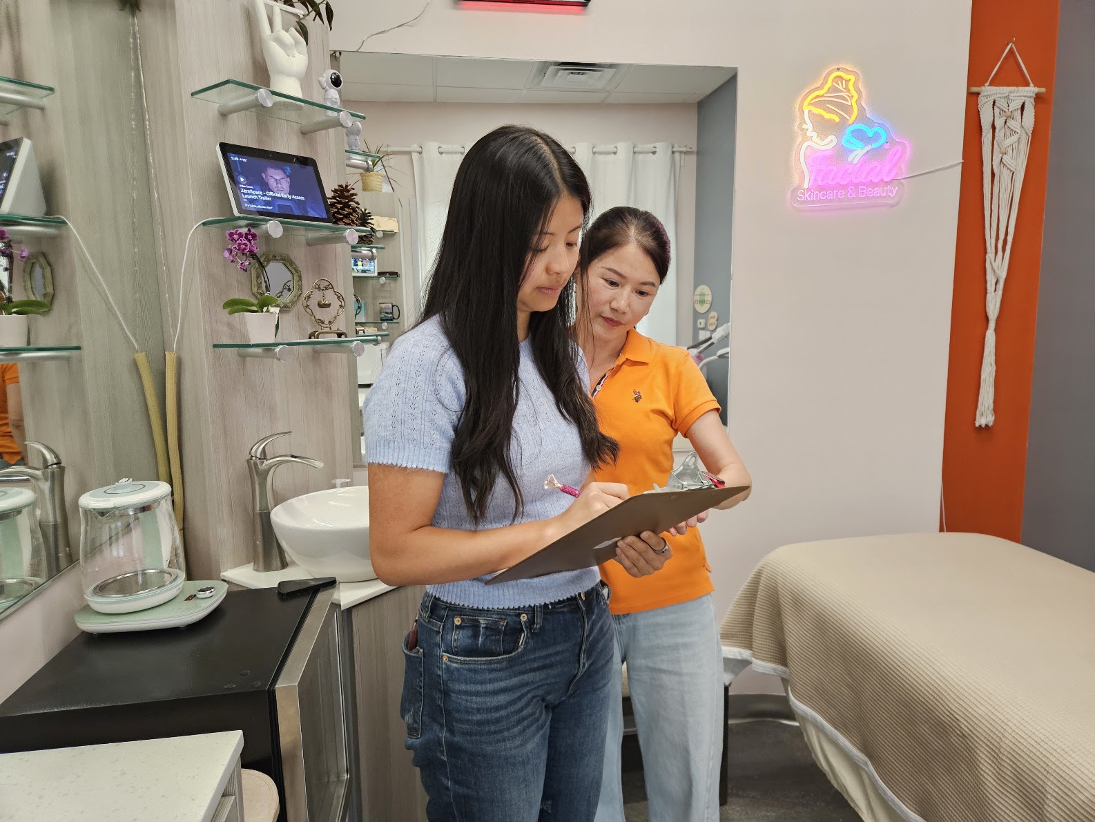 Ruiyu Lin consulting with a client at Ageless Skin Studio